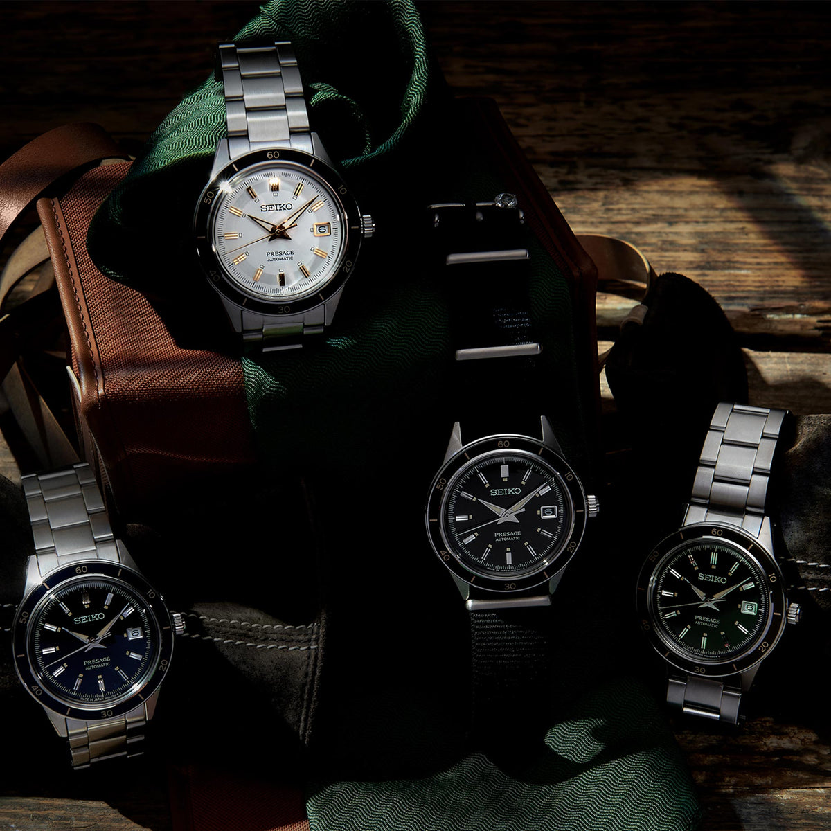 Men's stainless-steel wristwatch with white dial, gold hands, and black bezel on bracelet