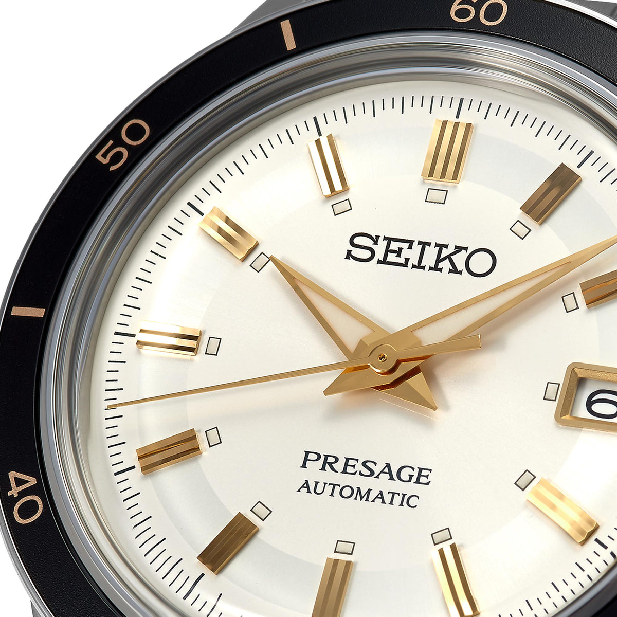 Close-up of white dial watch featuring gold markers, gold star-shaped hands, and Seiko text