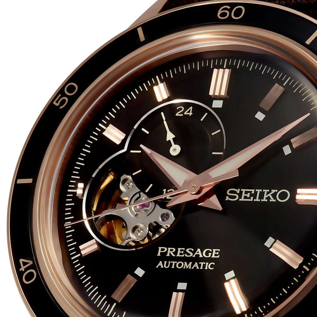 Close-up of men's black open-heart dial, open mechanism window, rose-gold hands and markers