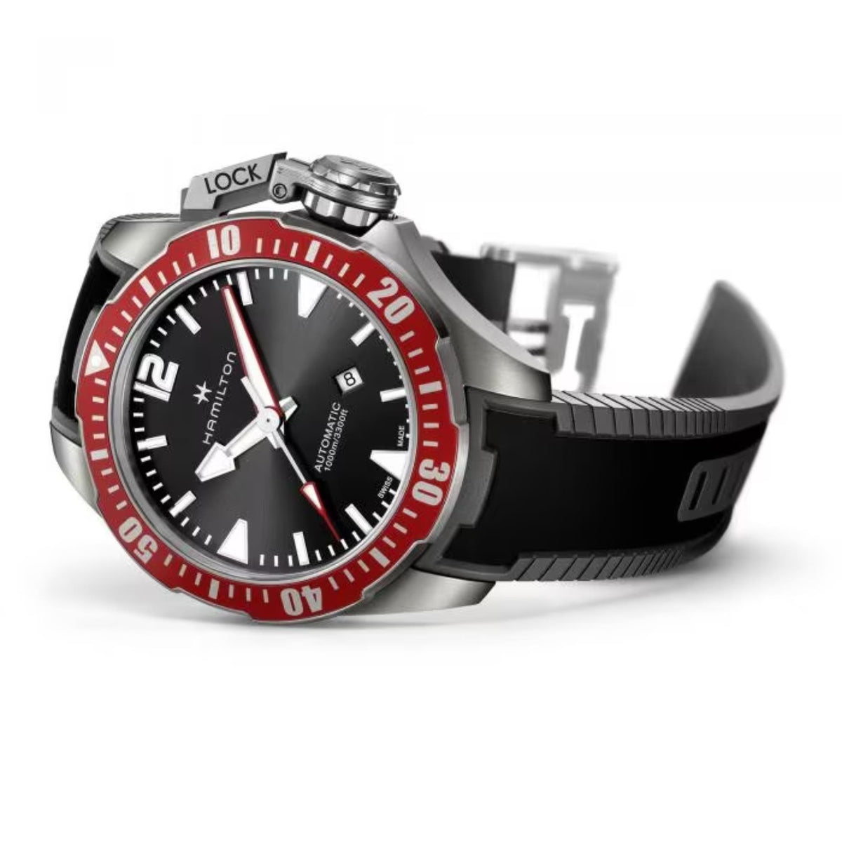 Angled view of automatic diver watch with black dial, red bezel, and black rubber strap