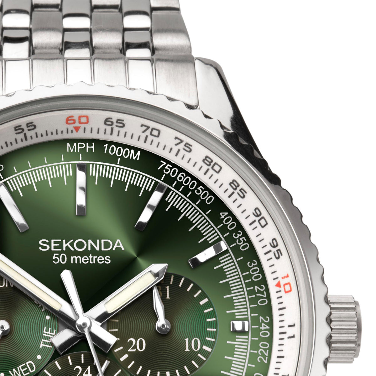 Green watch dial close-up with silver hands, tachymeter bezel, and small subdial