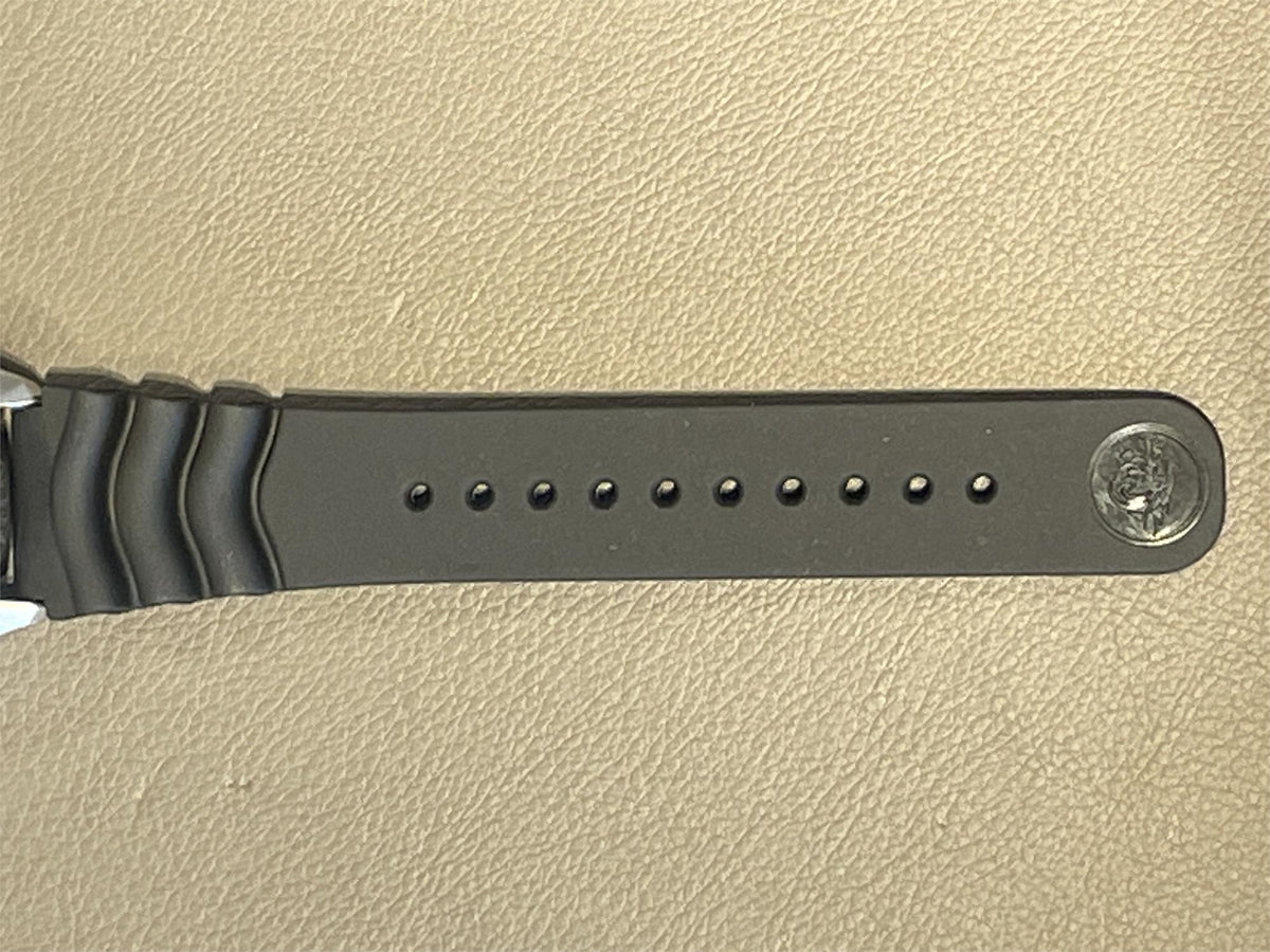 Seiko Diver’s Pepsi Automatic mens watch SKX009J1 strap with metal buckle on a beige background