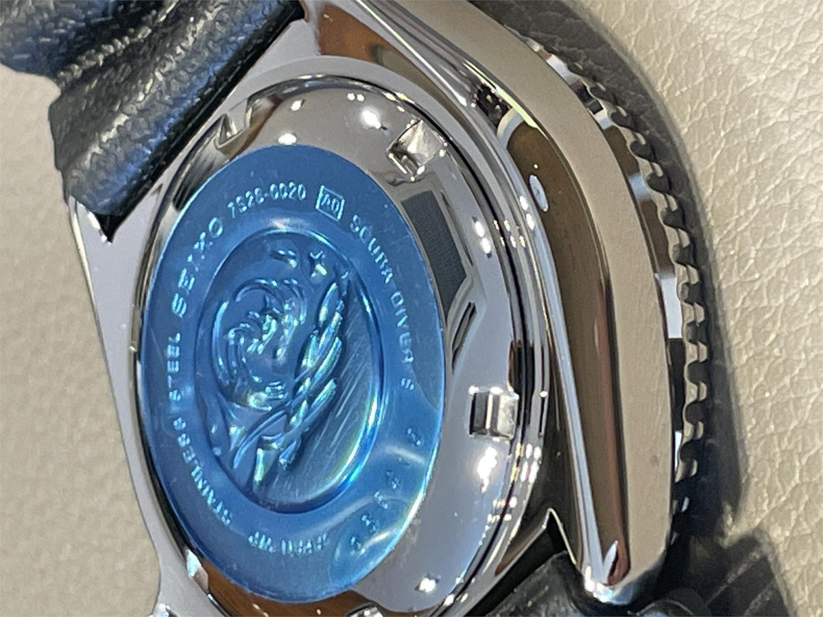 Close-up of Seiko Diver’s Pepsi mens watch case on a beige background
