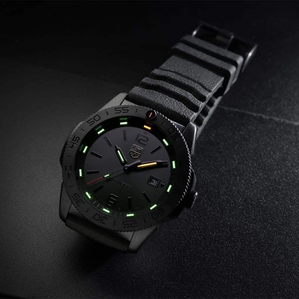 Men's black diver watch with black rubber band and luminous green markers on dark dial