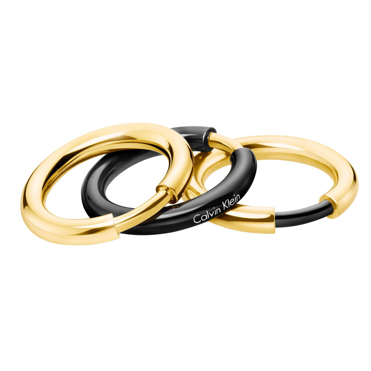 Three two-tone rings with thick gold-tone bands and dark black ring, Calvin Klein mark