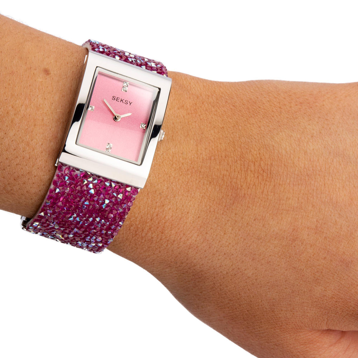 Seksy ladies watch on wrist, pink dial with rhinestone strap and silver square case