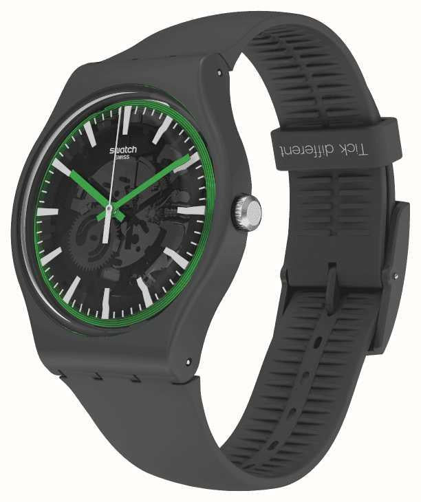Angled view of black watch with green-outlined skeleton dial and textured silicone strap