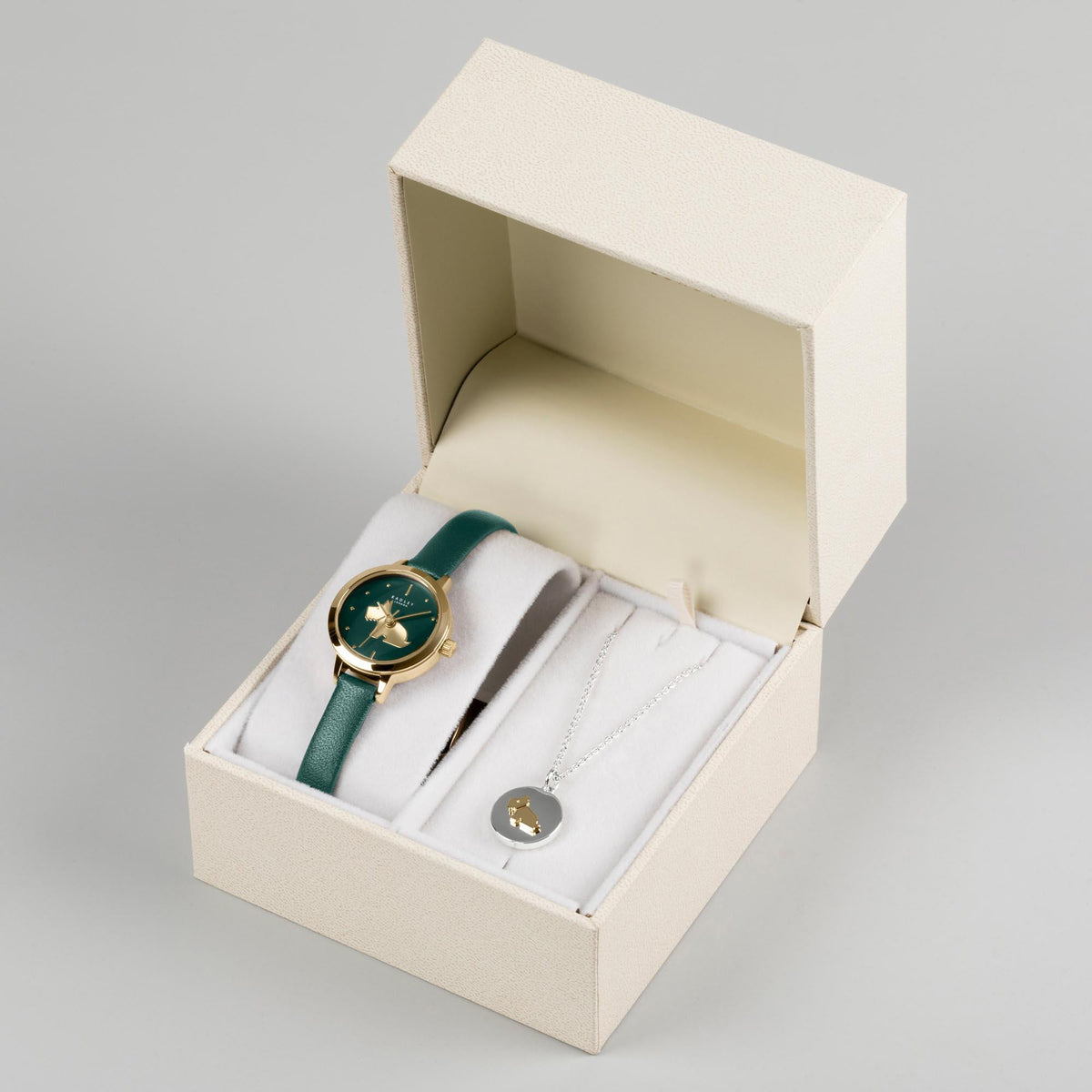 Watch and pendant necklace set in open gift box, dark green leather strap visible
