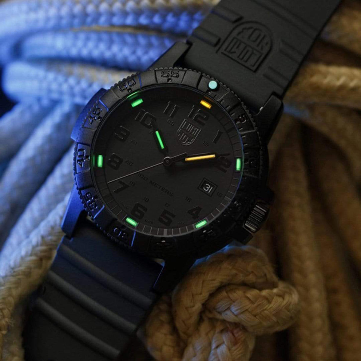 Angled view of the Luminox Leatherback Sea Turtle XS.0301.BO.L, with glowing illuminated tritium tube hands resting on coiled rope