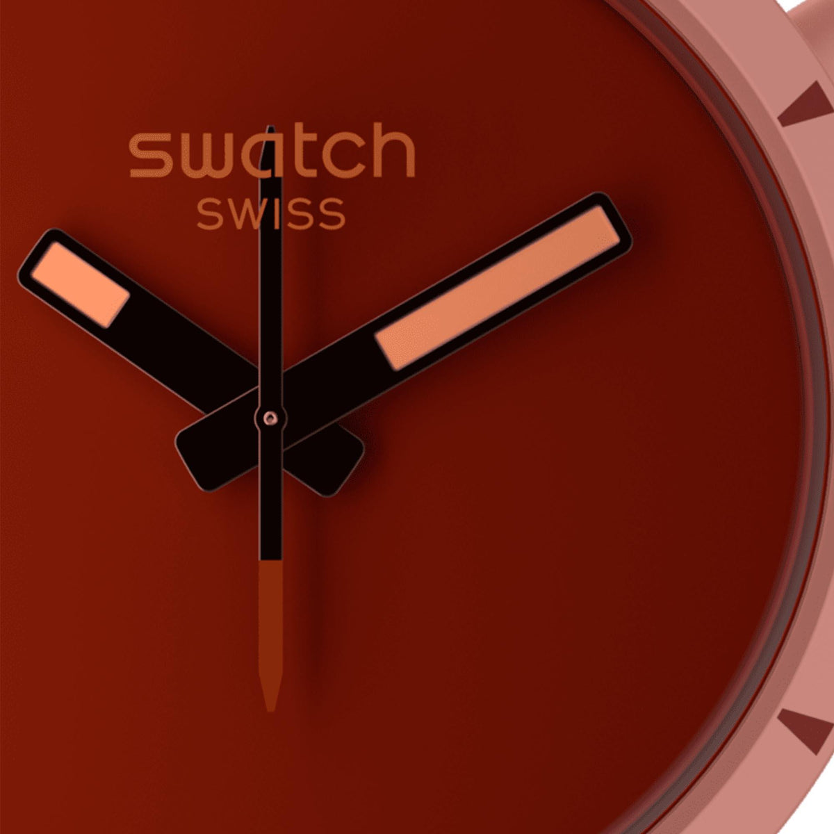 Red dial close-up with outlined markers and three-arrow watch hands