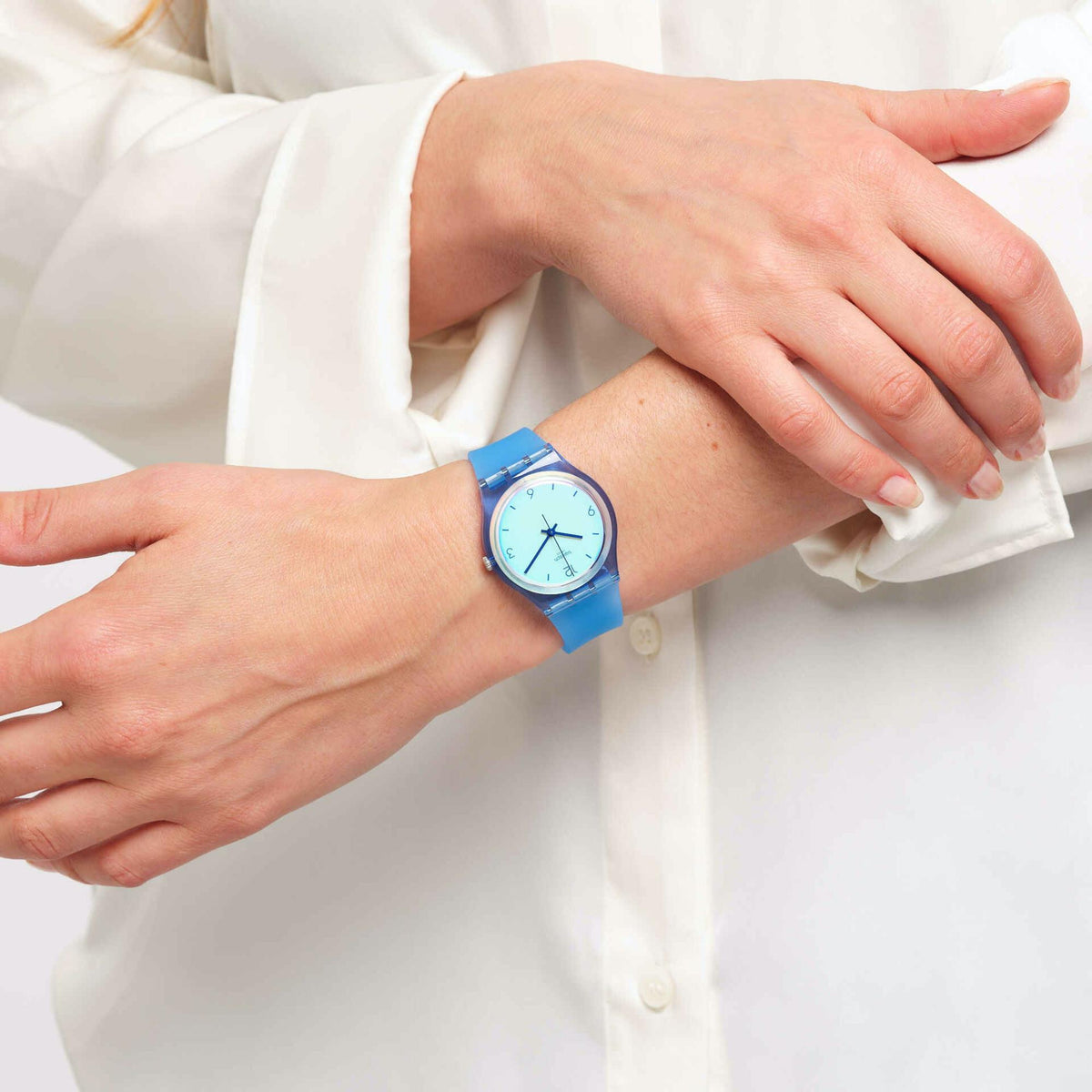 Blue transparent silicone analog watch on wrist with round light-blue dial