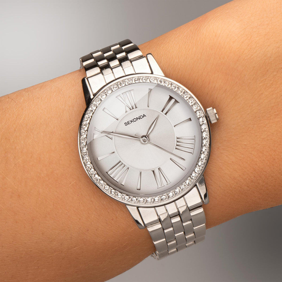 Ladies quartz watch with silver stainless bracelet, white dial, Roman numerals, crystal bezel
