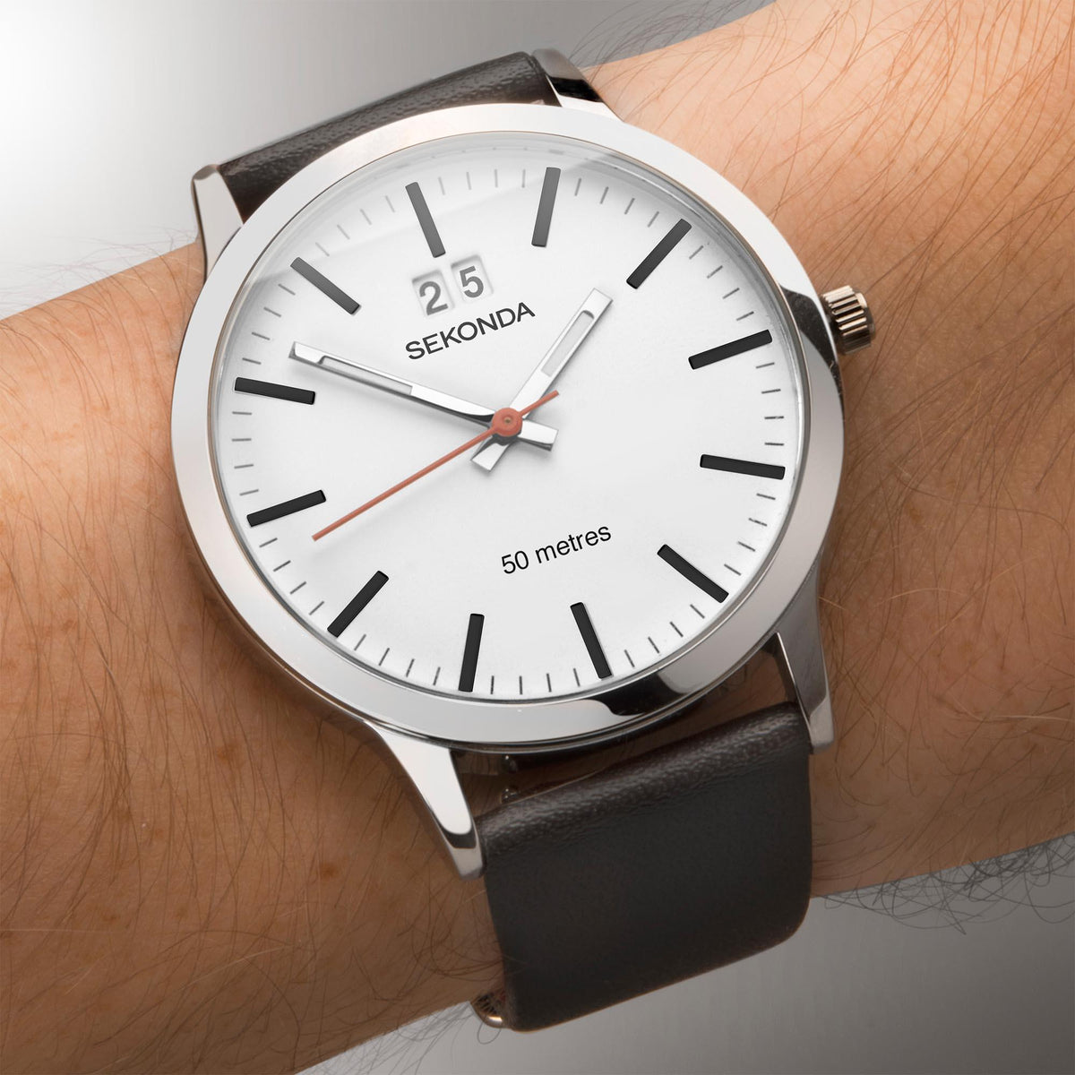Mens wristwatch on arm with white dial, black leather strap, silver case, red seconds hand