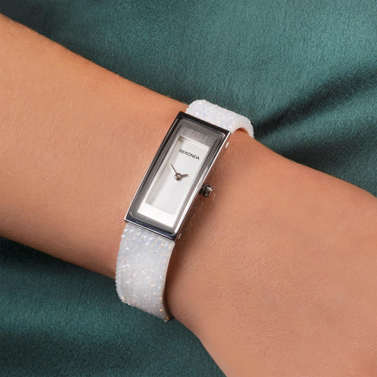 Sekonda rectangular ladies quartz watch on wrist with silver dial and white textured strap