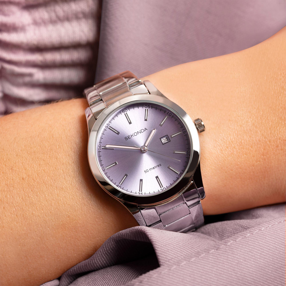 Sekonda ladies watch on wrist with purple dial, date window, and stainless bracelet