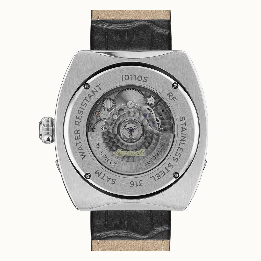 Automatic watch caseback showing movement, silver case and black leather strap
