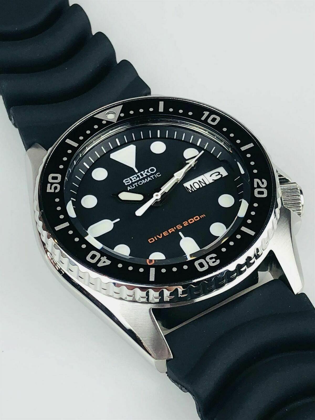 Men's diver's automatic watch with black dial, bezel markers, and black rubber strap