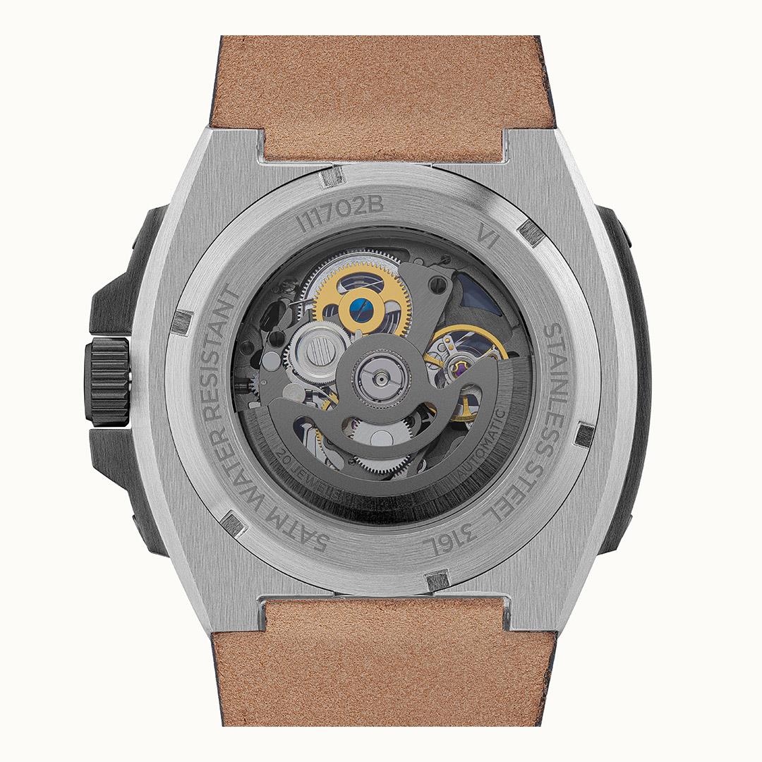 Automatic skeleton watch back view with visible movement and steel case edges