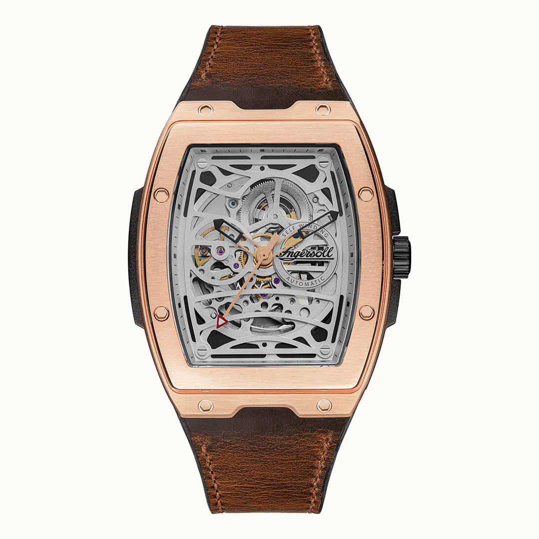 Automatic skeleton dial watch with rose-gold case and brown leather strap, visible gears.