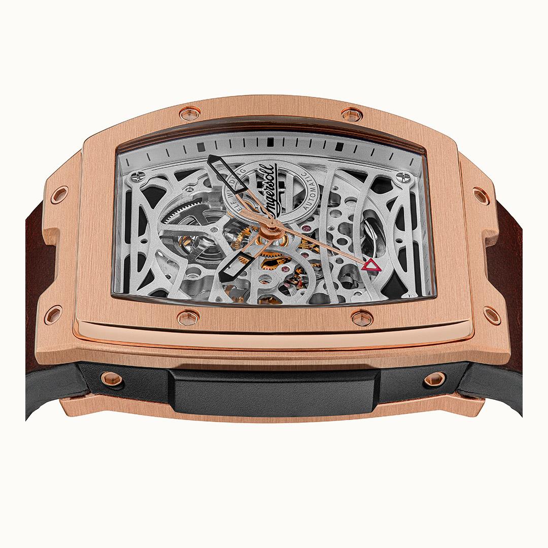 Automatic skeleton watch with rose-gold case, brown strap, orange-accented gears visible