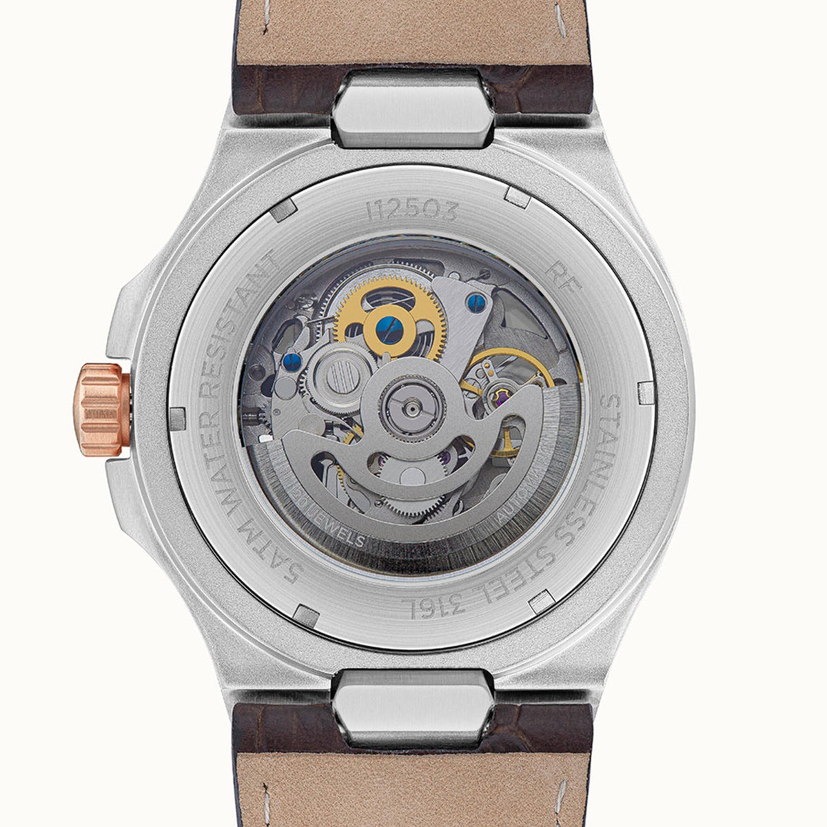 Men's automatic skeleton watch rear view with silver case, visible movement, brown leather strap