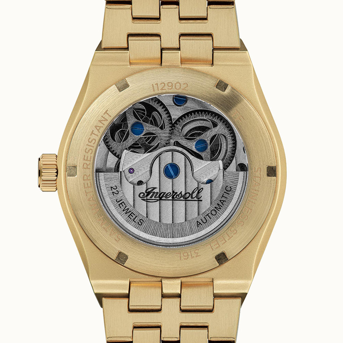 Gold-tone automatic skeleton men's watch caseback with exposed gears and blue jewel details