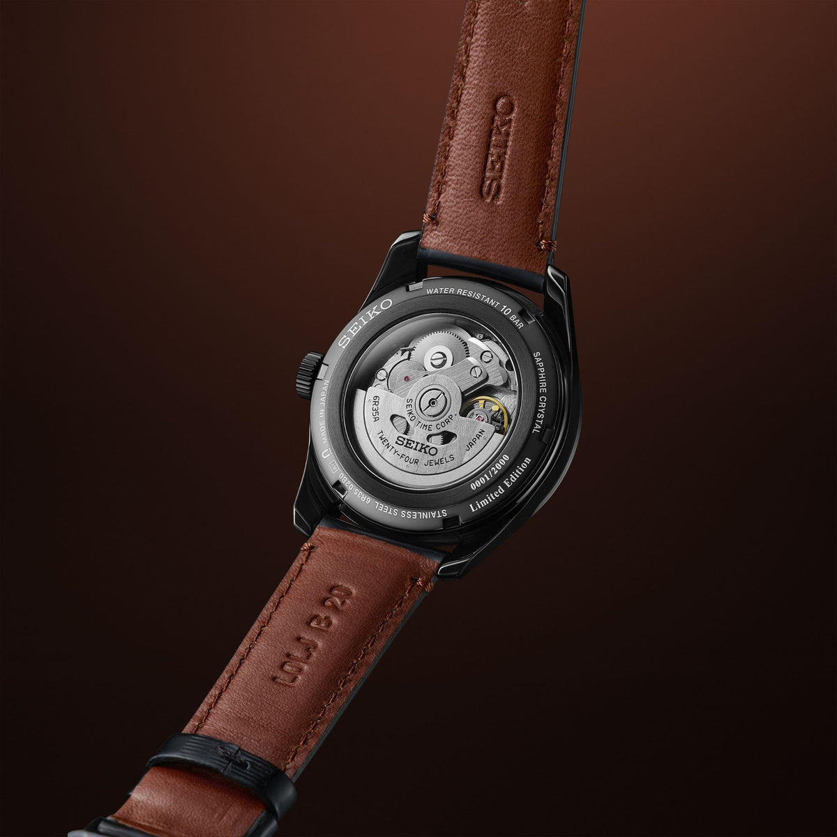 Seiko Presage men’s watch caseback with brown leather strap and black case sides visible.