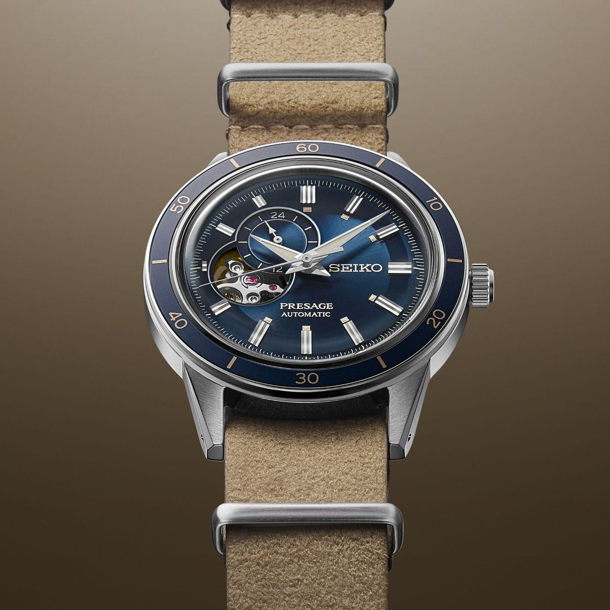 Automatic watch close-up on beige leather strap with blue dial and metallic bezel