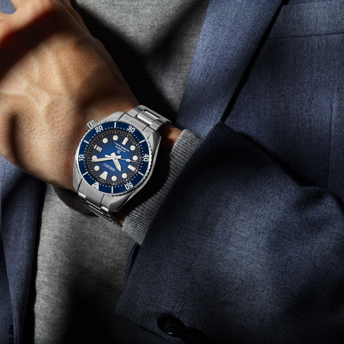 Seiko men's divers watch on wrist with blue dial and stainless-steel bracelet