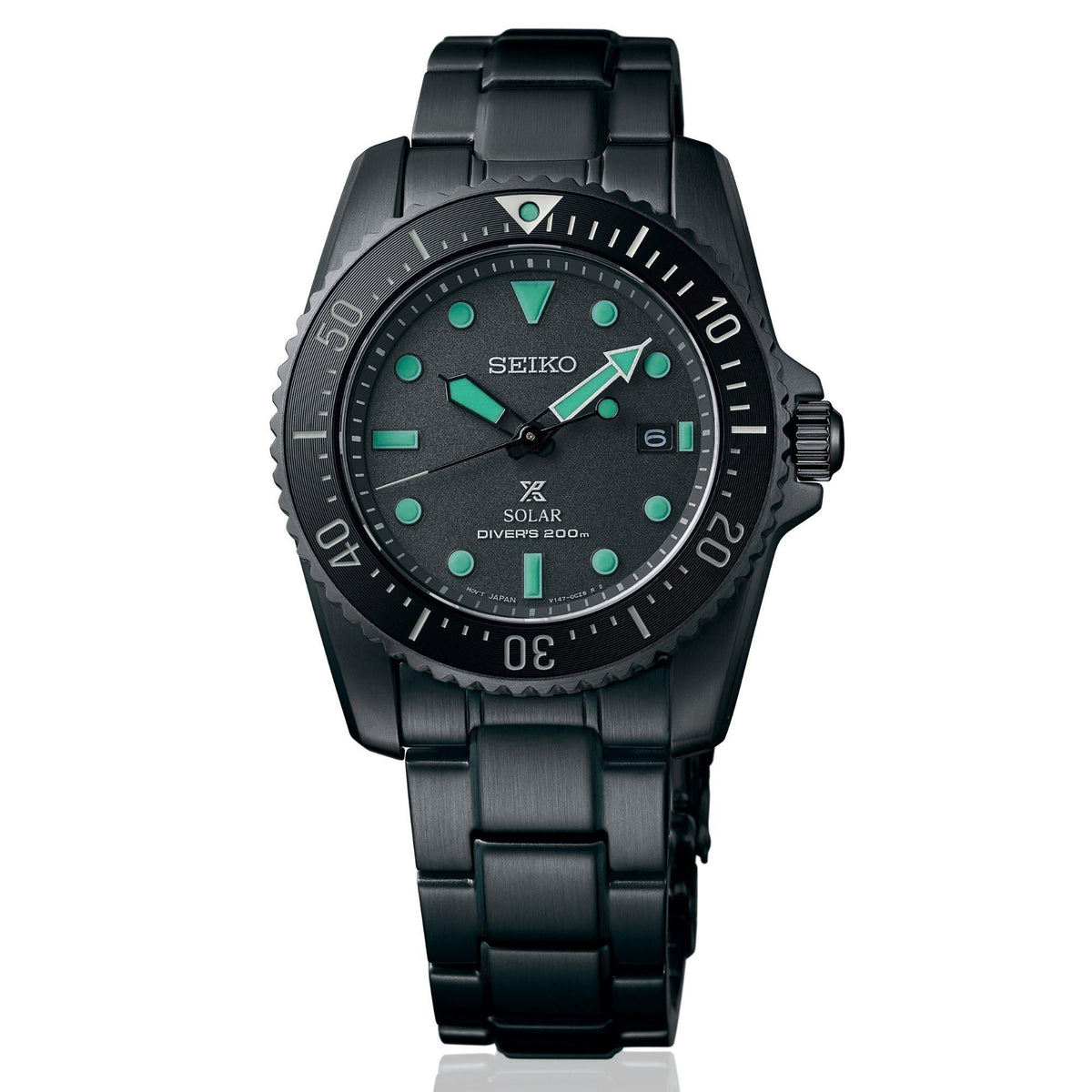 Black solar diver watch featuring green markers and date window on black dial