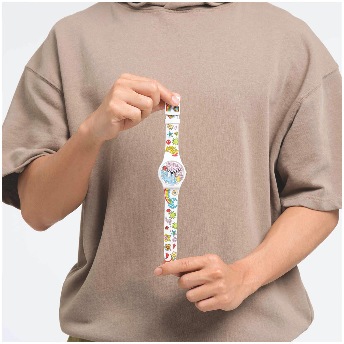 Swatch silicone quartz watch on wrist with multicolour patterned strap and dial