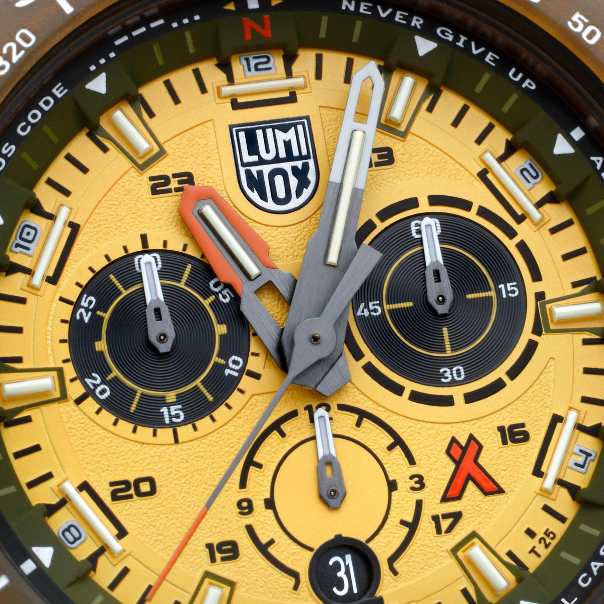Close-up of yellow watch dial with LUMINOX logo, luminous markers, and subdial details
