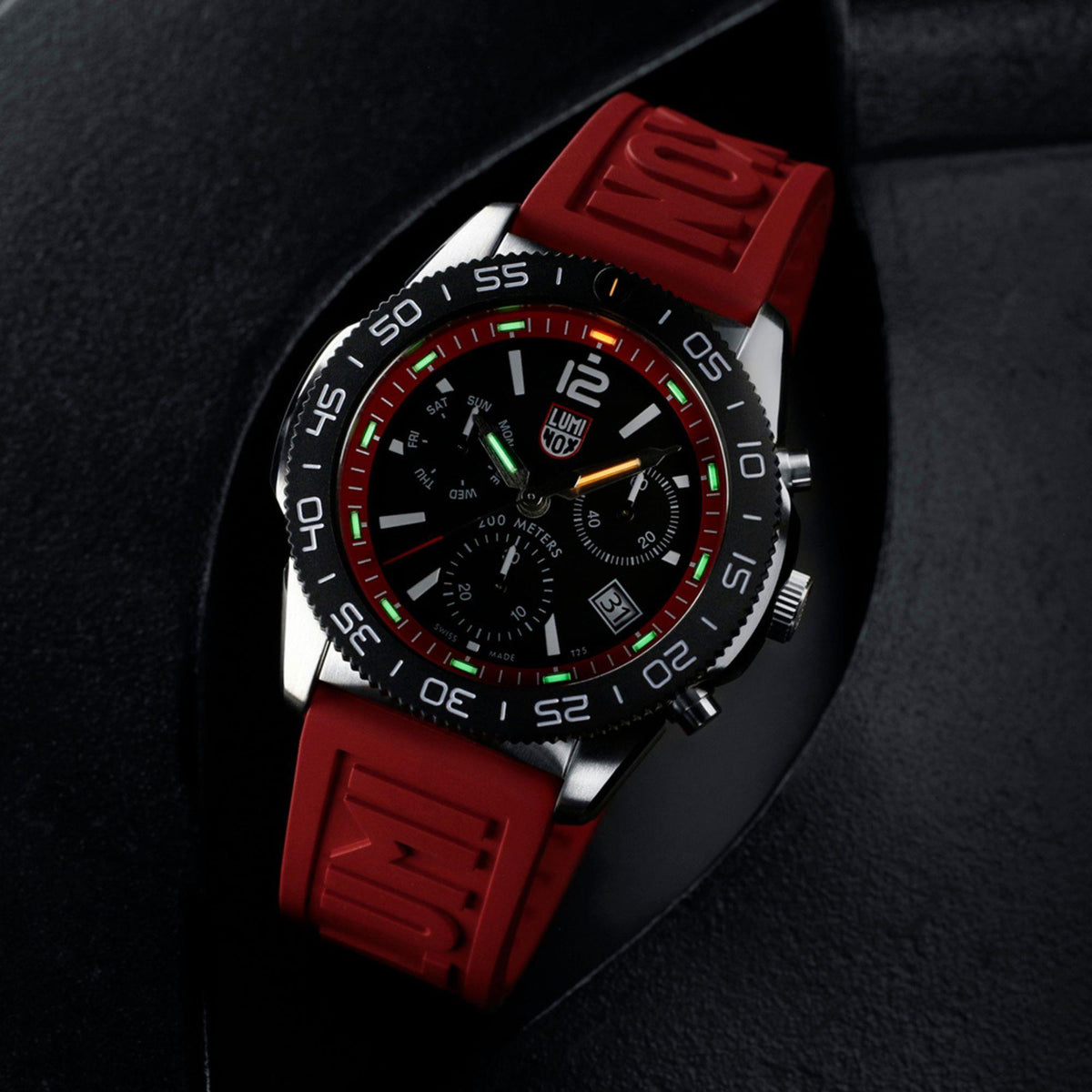 Men's diver chronograph watch front view with black dial, red rubber strap, and luminous details.