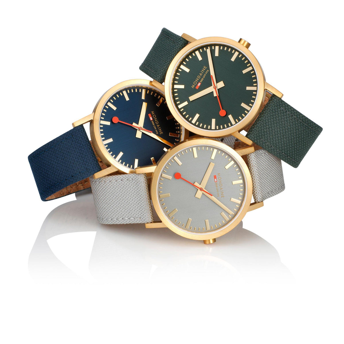 Mondaine Classic watches with fabric straps in dark blue, green, and gray
