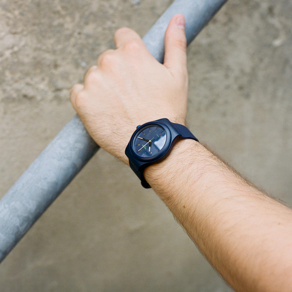 Men's dark-blue sports watch on wrist, round blue dial with metal hands