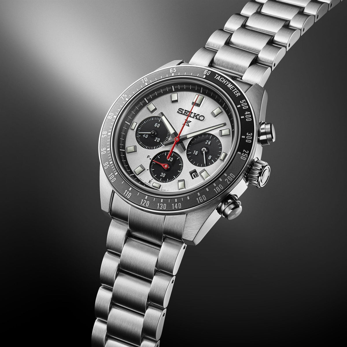 Stainless steel chronograph watch angled side view, silver dial with three subdials and date window