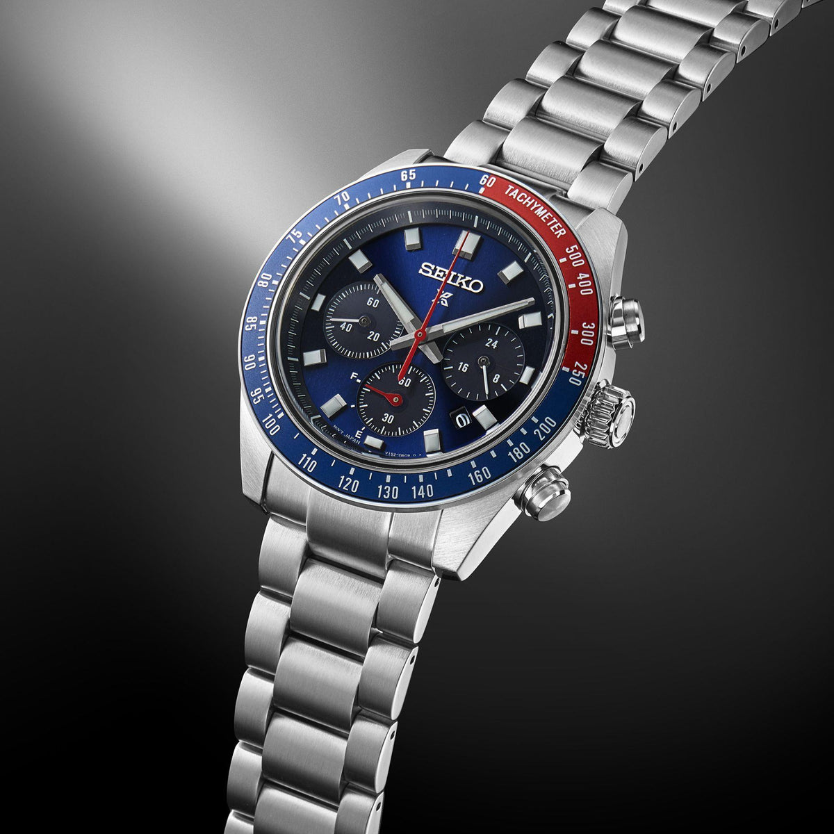 Men's solar chronograph watch side view with blue dial and steel bracelet links