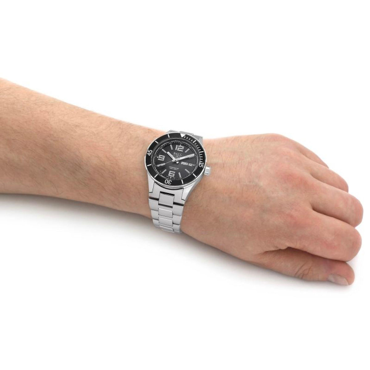 Men's automatic watch on wrist with black dial and silver metal bracelet