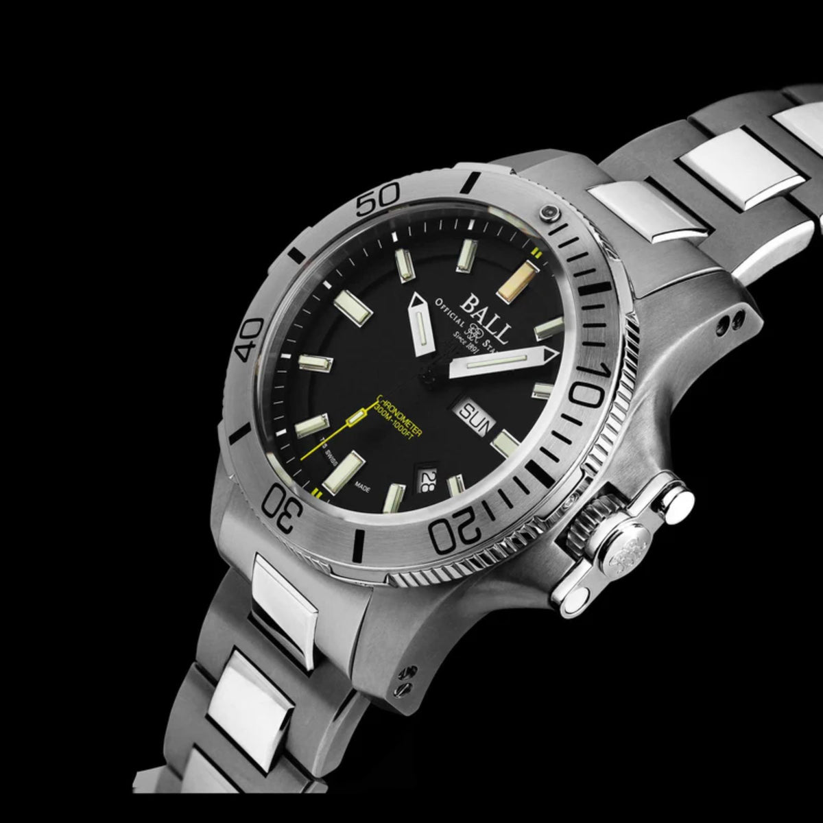 Men's stainless steel watch close-up with black dial, luminous hands, and date window