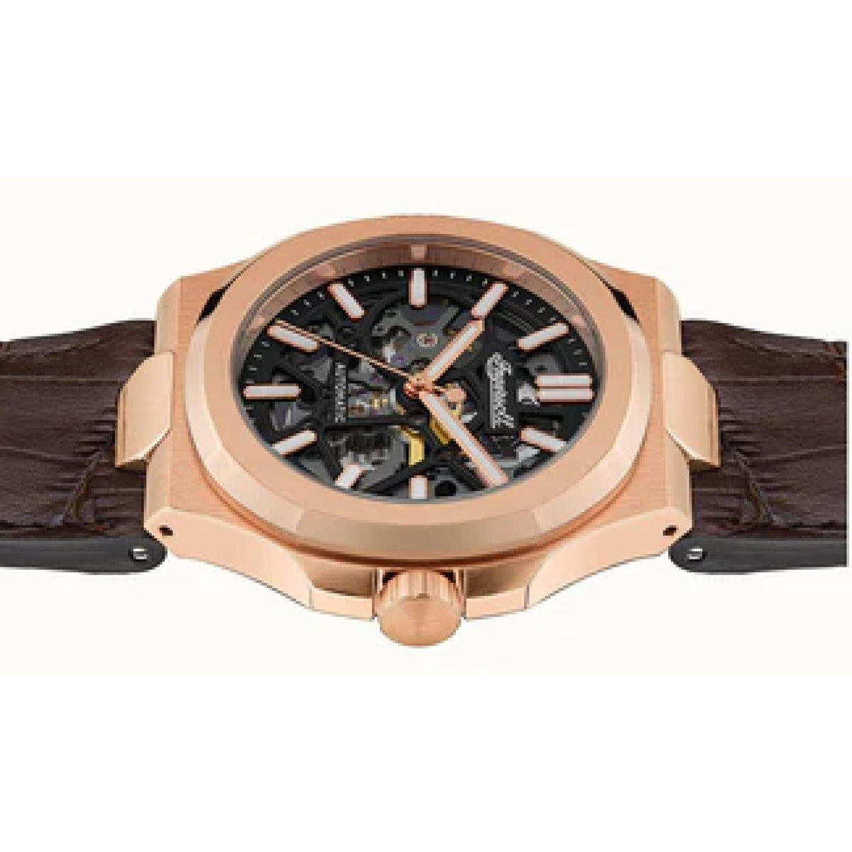 Rose gold skeleton watch with black dial and brown leather strap, visible crown