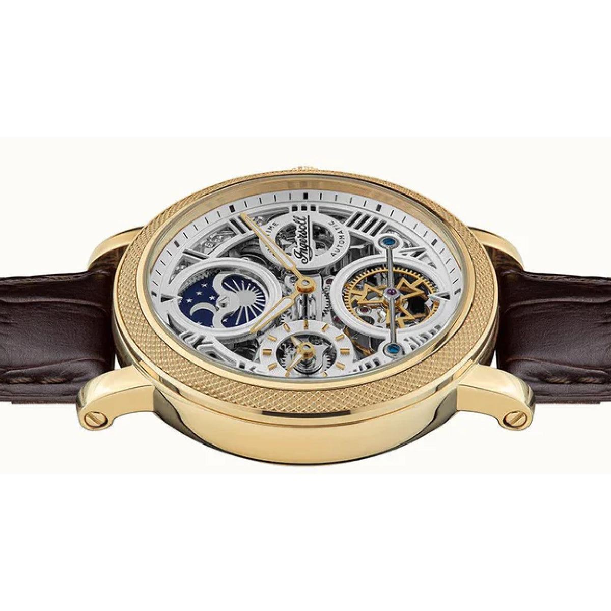 Men's automatic watch angled view with skeleton dial, brown leather strap, and gold-tone case