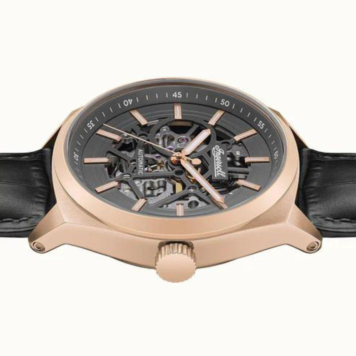 Top view of automatic watch with grey skeleton dial and rose-gold caseback