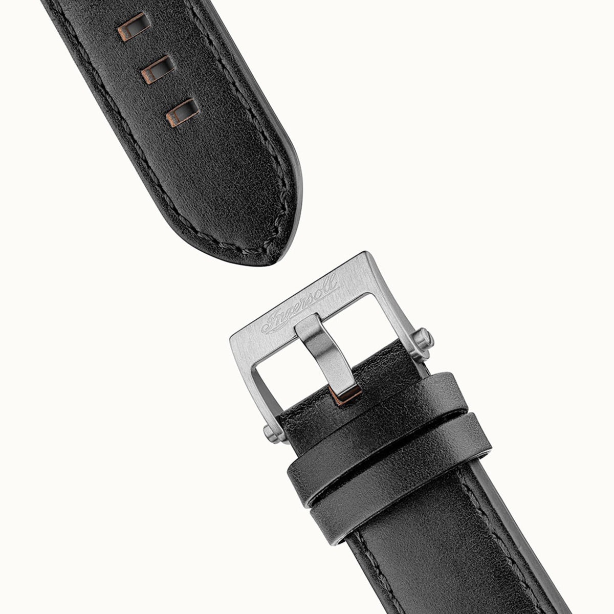 Black leather watch band close-up with metal buckle and stitch detailing