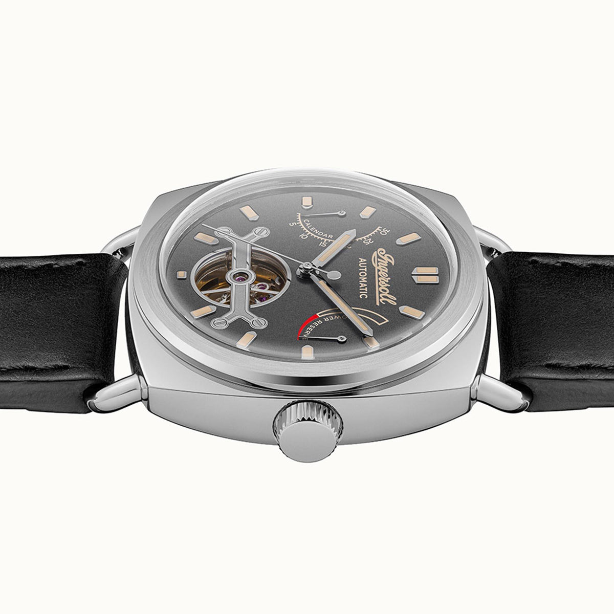 Men's automatic watch with grey dial, visible movement, black leather strap and crown.