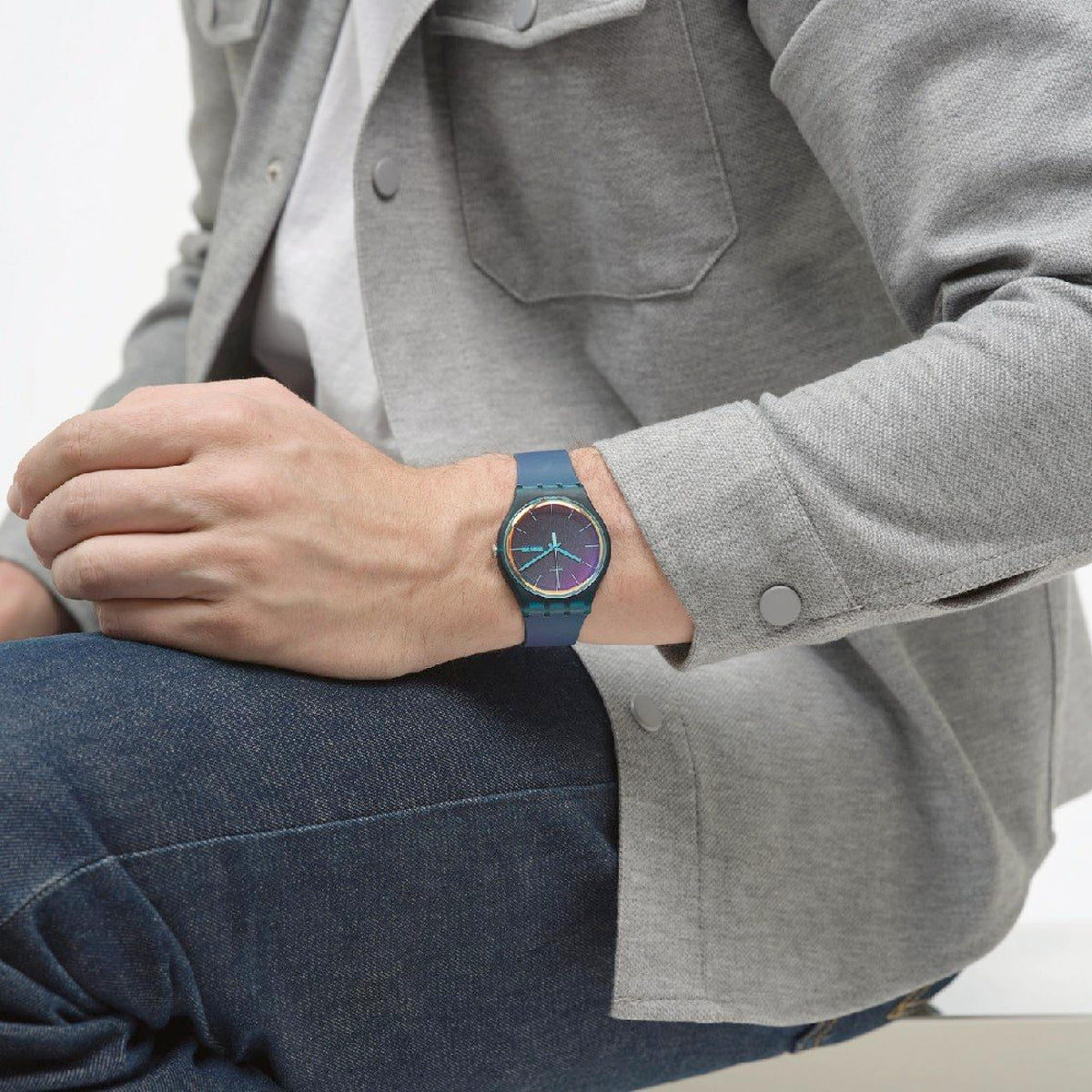Ladies quartz watch on wrist with dark teal strap and iridescent blue-purple dial