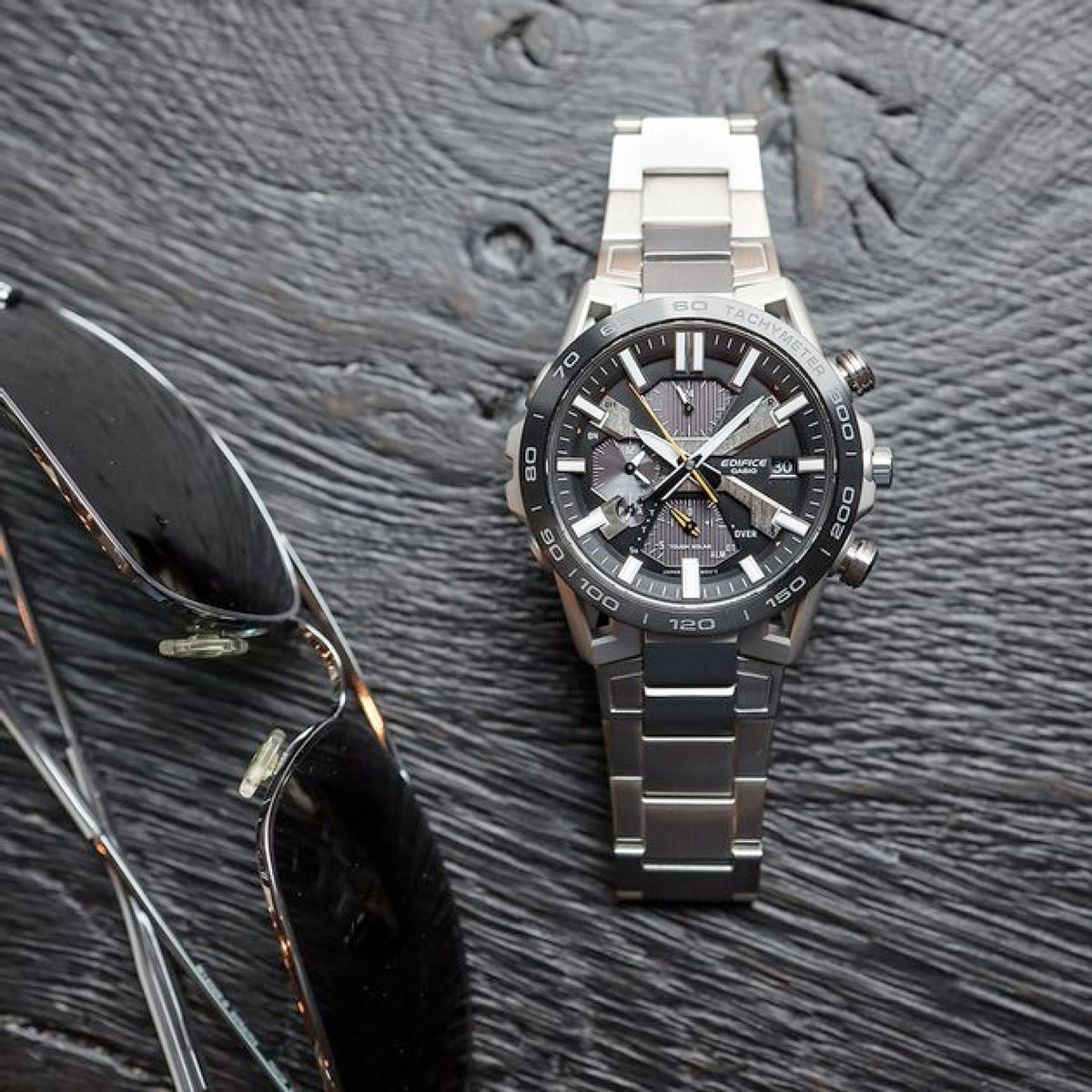 Men's steel chronograph watch on bracelet with black dial and orange-accented hands
