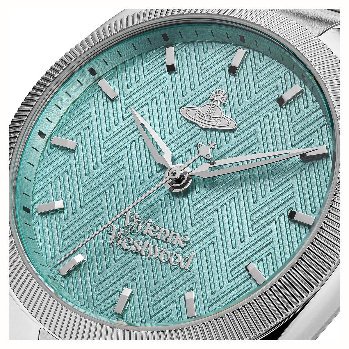 Close-up of turquoise patterned watch dial with hour markers and hands