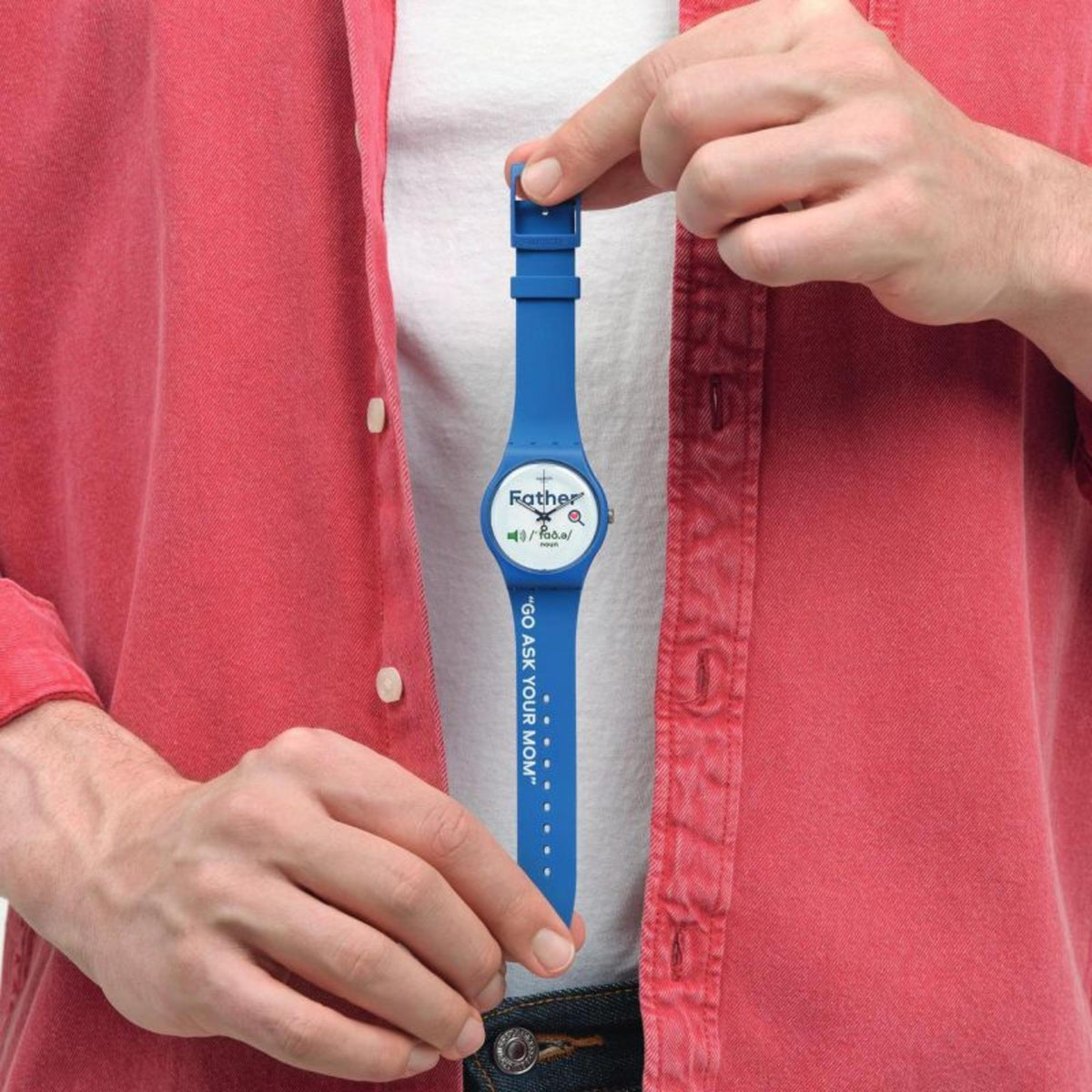 Blue silicone strap watch with white dial on wrist, visible “Father” text