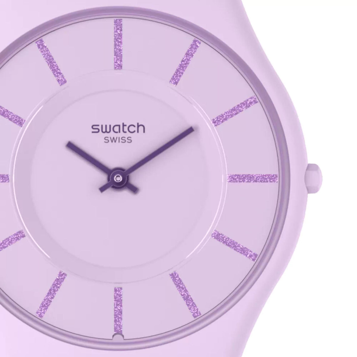 Quartz watch dial close-up with purple glitter indices, dark hands, and lilac case