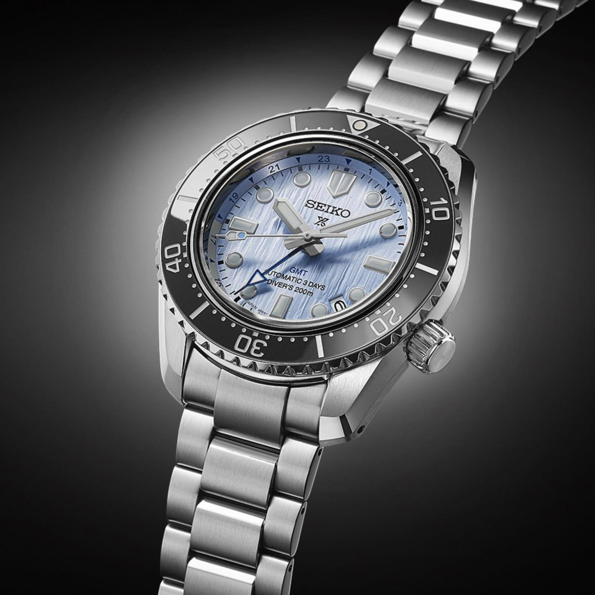 Men's steel diver watch with blue dial and black bezel, angled view